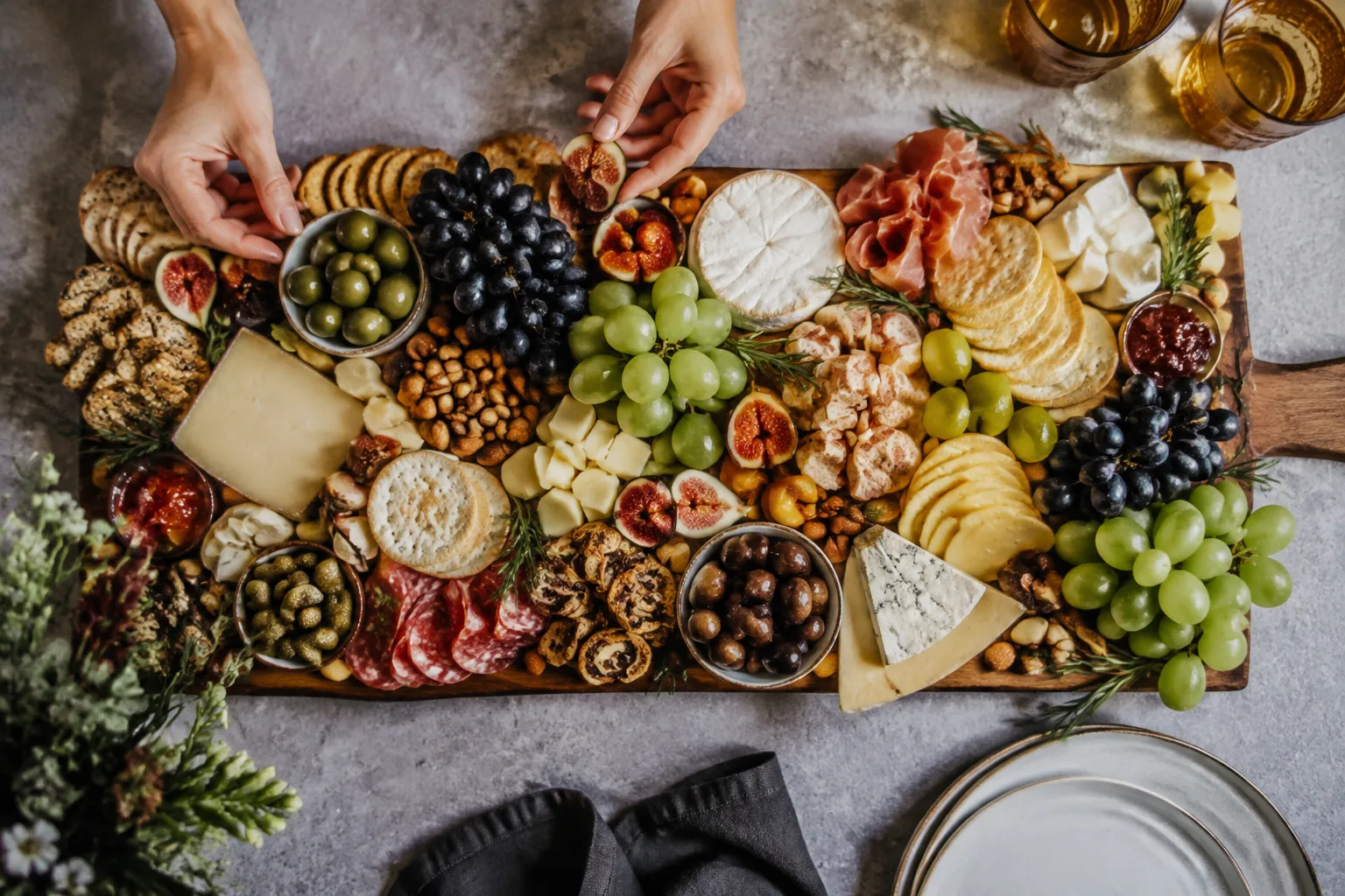 Grazing spread with cheeses, figs, grapes, crackers and olives